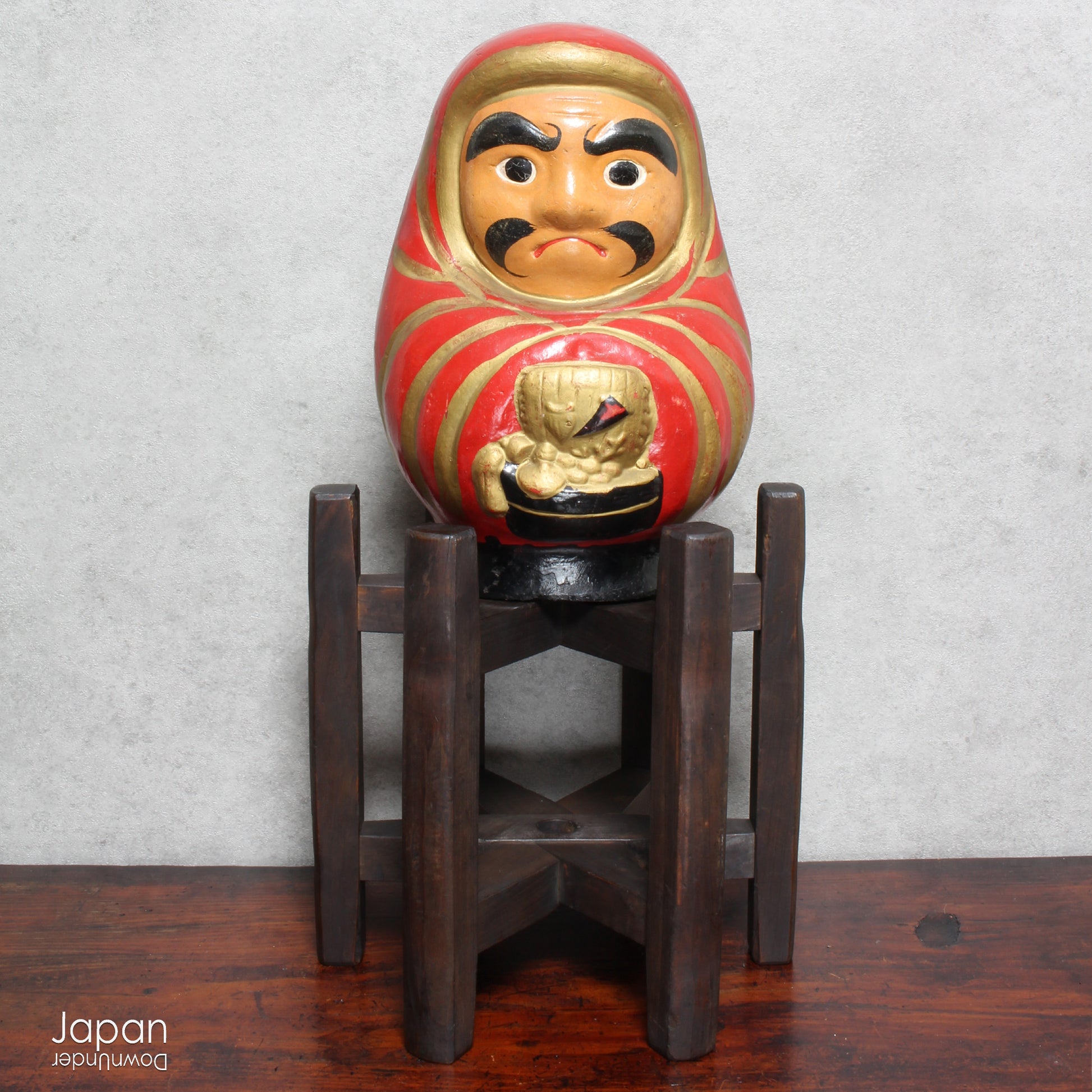 Add a touch of history to your home with this large antique Meiji Era lucky Daruma clay doll. No longer in production it boasts a great darkened rustic patina that adds unique charm to any space. Bring a piece of the past into your modern decor.