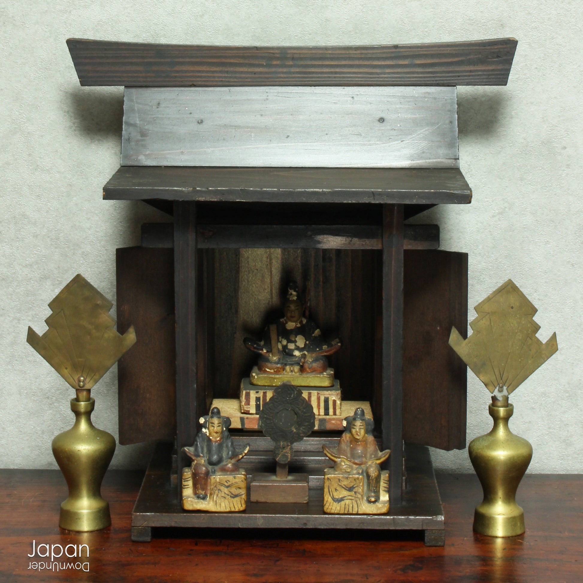 A perfect addition to your spiritual space, this quaint rustic antique Shinto shrine, made to be placed on the kamidana (god shelf), houses the lucky god Tenjin, protected by his guards. The charming hand crafted god house embodies the essence of Shinto folk faith