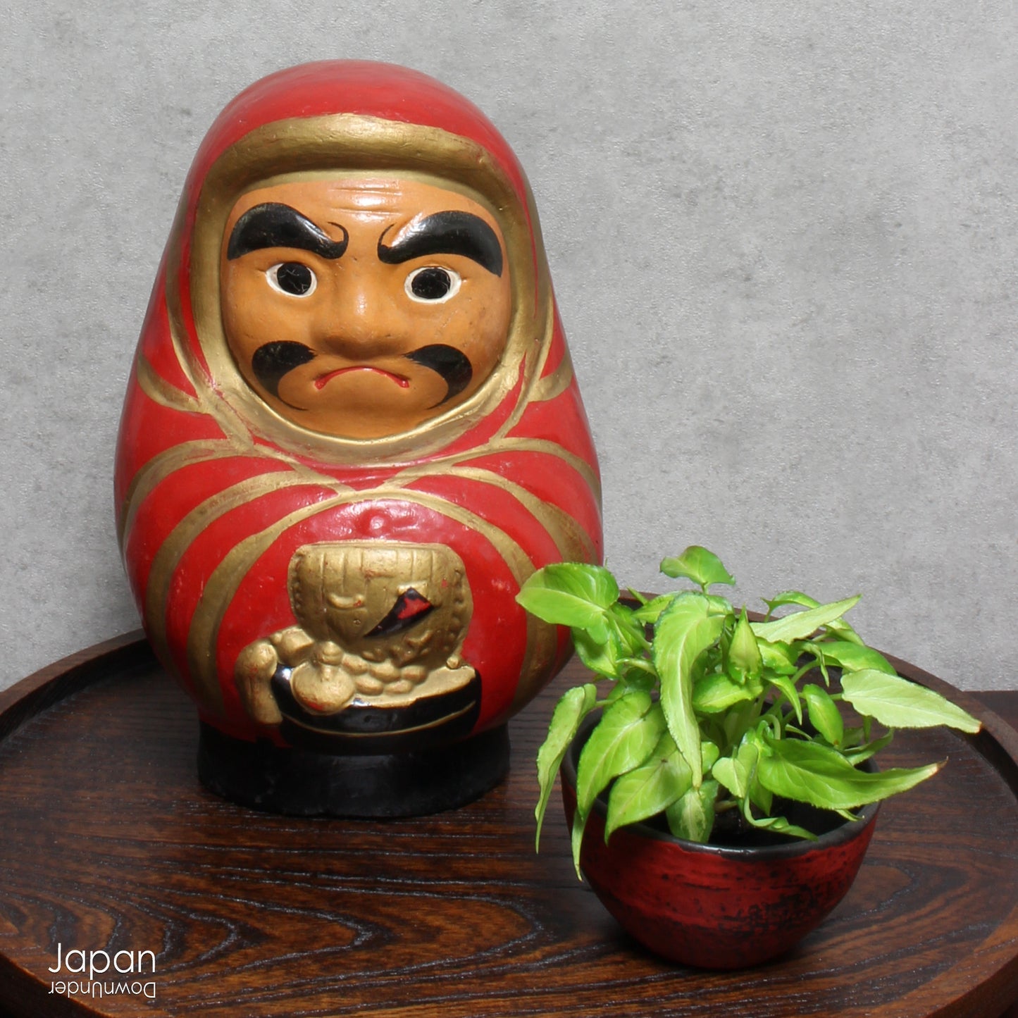 Add a touch of history to your home with this large antique Meiji Era lucky Daruma clay doll. No longer in production it boasts a great darkened rustic patina that adds unique charm to any space. Bring a piece of the past into your modern decor.