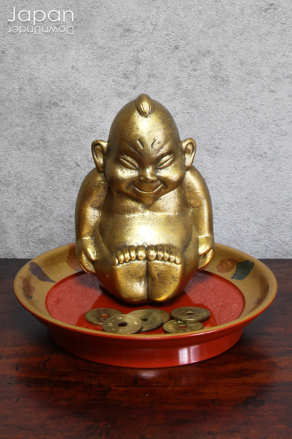 A cute ceramic statue of Billiken, The God of Things As They Ought To Be! It is good luck to rub the soles of his feet and offer some money to this god who resides in Osaka.  A five yen piece is usually offered as it is particularly lucky.