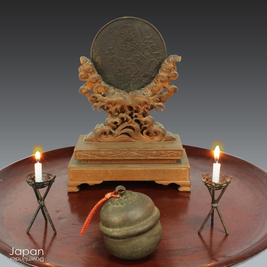 Discover an extraordinary piece of history with this stunning, one-of-a-kind Shinto shrine mirror from the Edo period. This rare treasure, displayed on an exquisitely carved wooden stand, beautifully merges history, spirituality, and artistry. The piece is complete with delicate metal candle holders, making it a perfect addition to any collection or spiritual space.