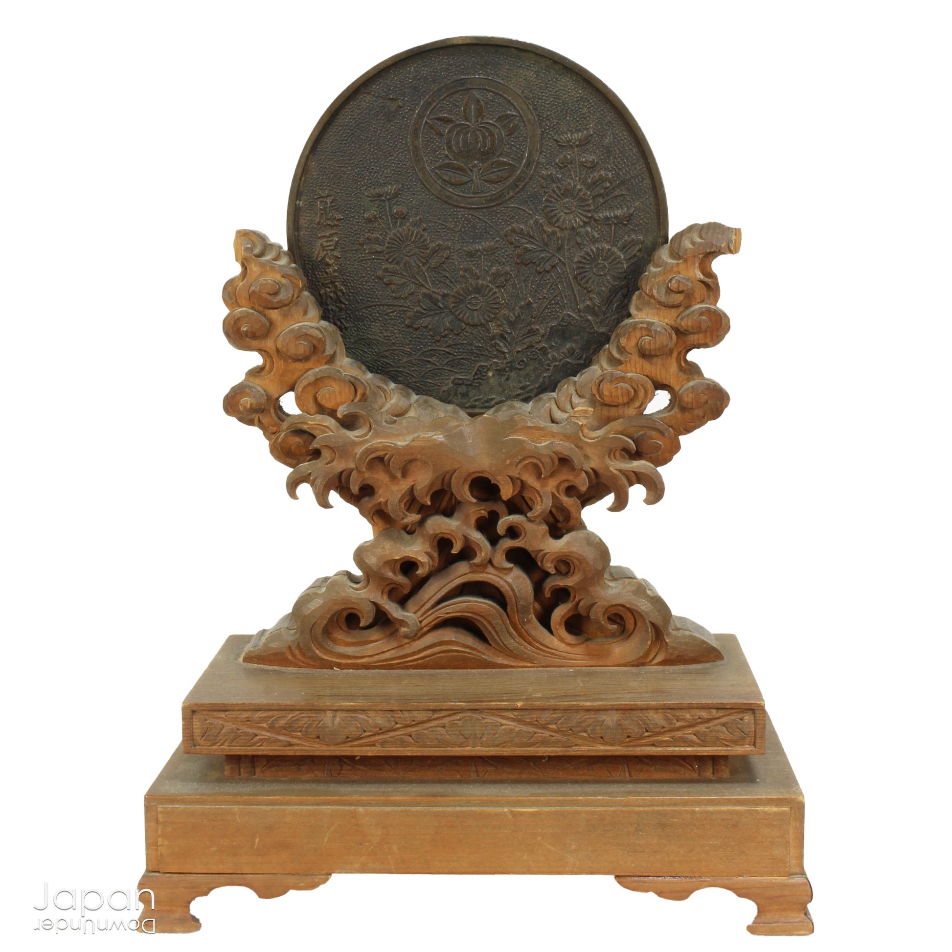 Discover an extraordinary piece of history with this stunning, one-of-a-kind Shinto shrine mirror from the Edo period. This rare treasure, displayed on an exquisitely carved wooden stand, beautifully merges history, spirituality, and artistry. The piece is complete with delicate metal candle holders, making it a perfect addition to any collection or spiritual space.